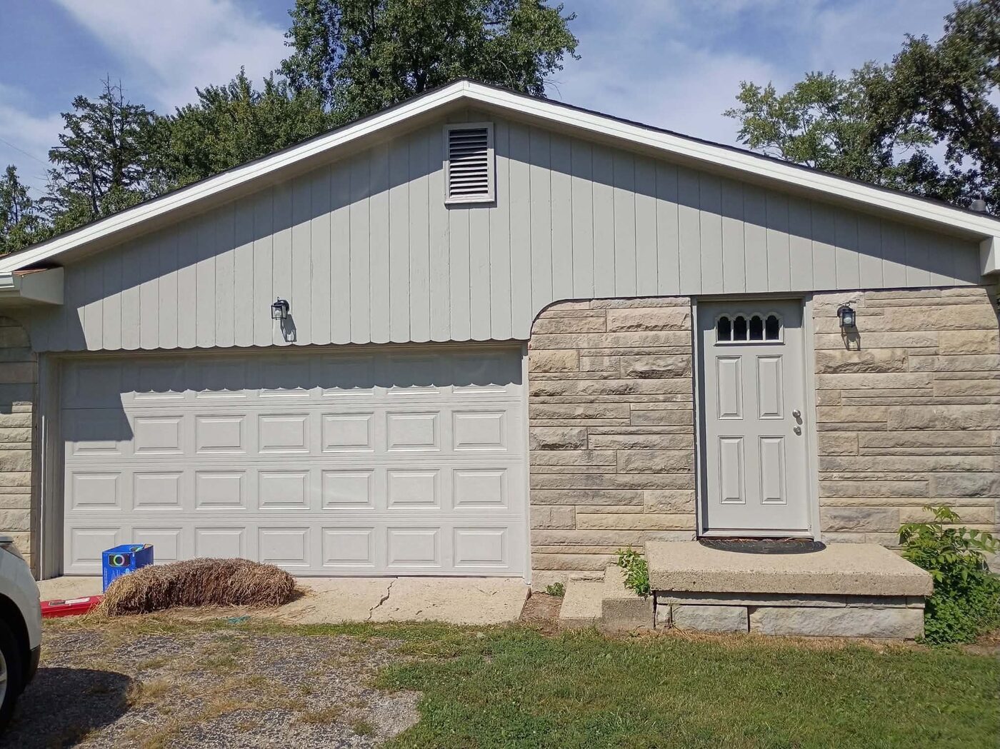 Same garage exterior after painting, with a clean refreshed finish
