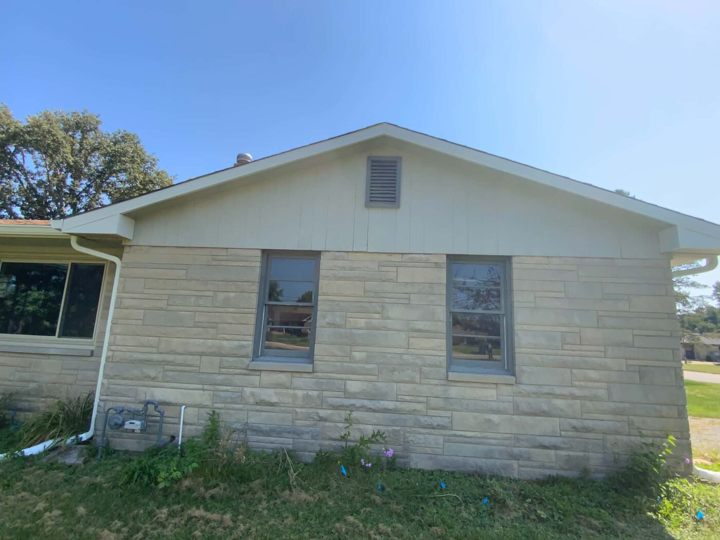 Exterior gable end before painting, showing the original siding