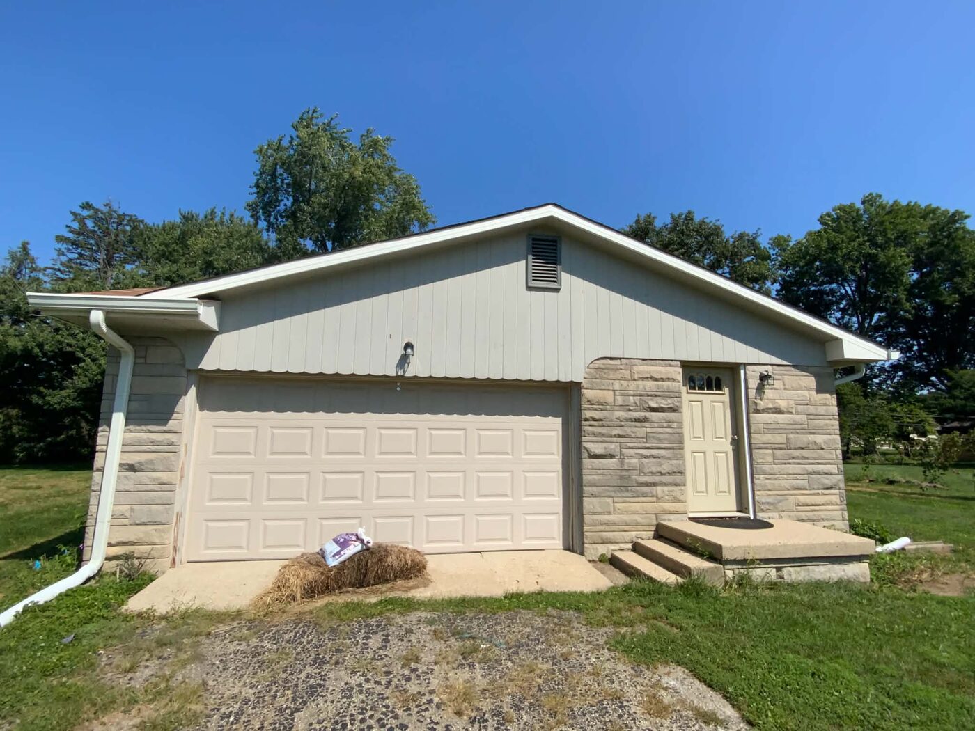 Garage exterior before painting, showing the original finish